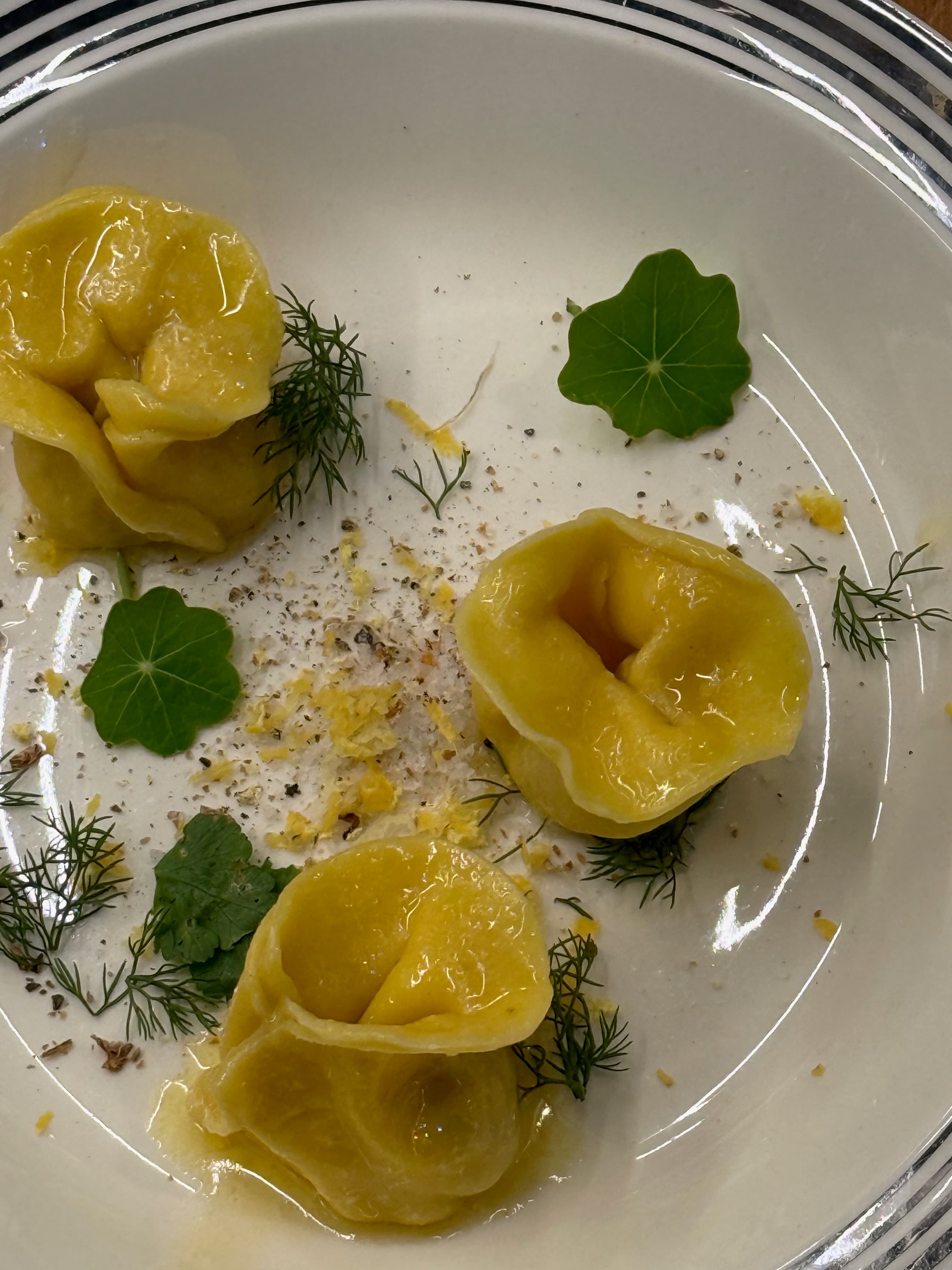 Handmade tortellini plated for service at Coq au Vin.